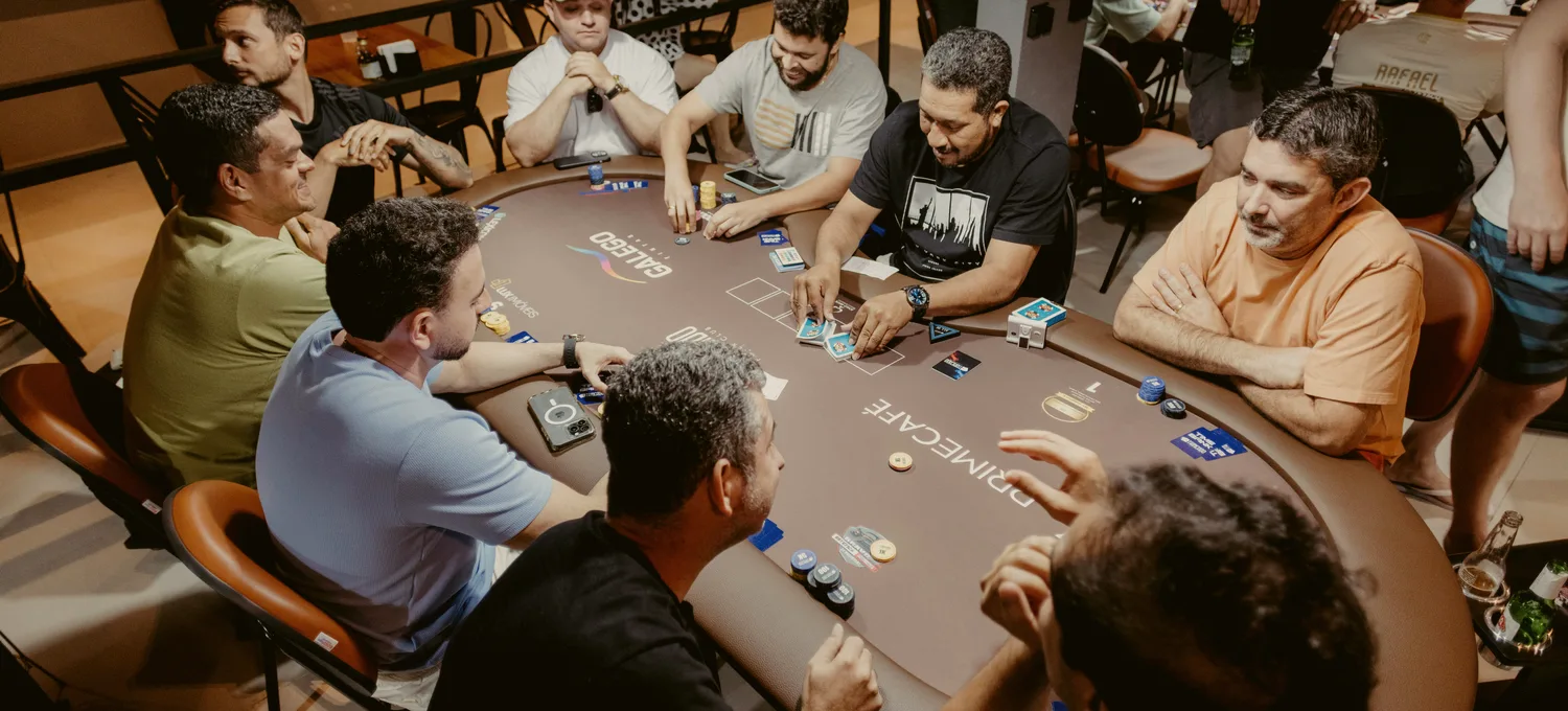 Tournament poker table under stage lighting with chip stacks